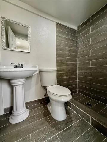 a bathroom with a toilet and a sink