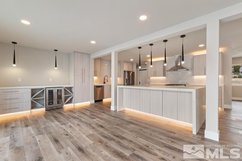 995 Skyline Boulevard Reno, NV 89509 - Photo 15 of 34 a large kitchen with stainless steel appliances kitchen island a large counter top and wooden floors