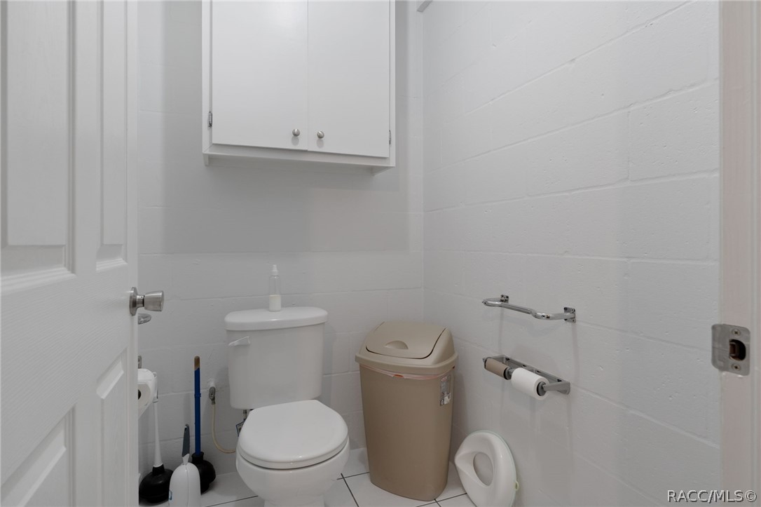 4530 South Florida Avenue Inverness, FL 34450 - Photo 64 of 100 a white toilet sitting next to a bathroom sink and vanity