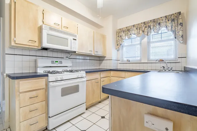 a kitchen with granite countertop a sink and cabinets