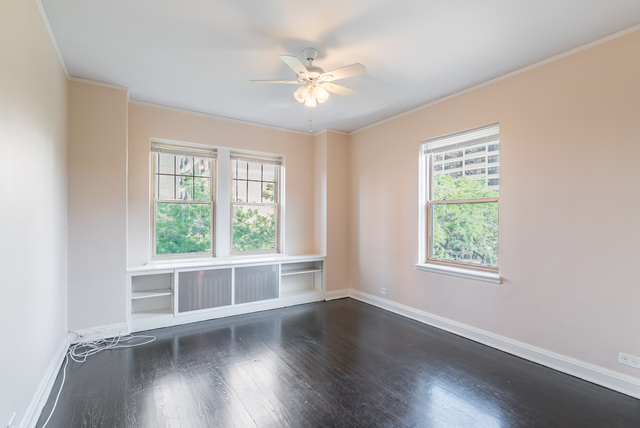 5000 South Cornell Avenue, Unit 3A Chicago, IL 60615 - Photo 5 of 14 a view of an empty room with wooden floor and a window