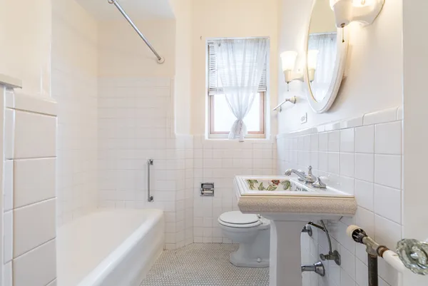 a bathroom with a sink a toilet and bathtub