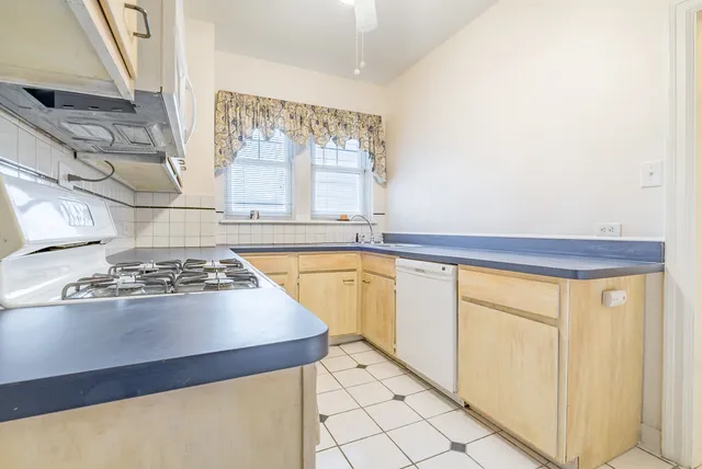 a kitchen with a stove and a refrigerator