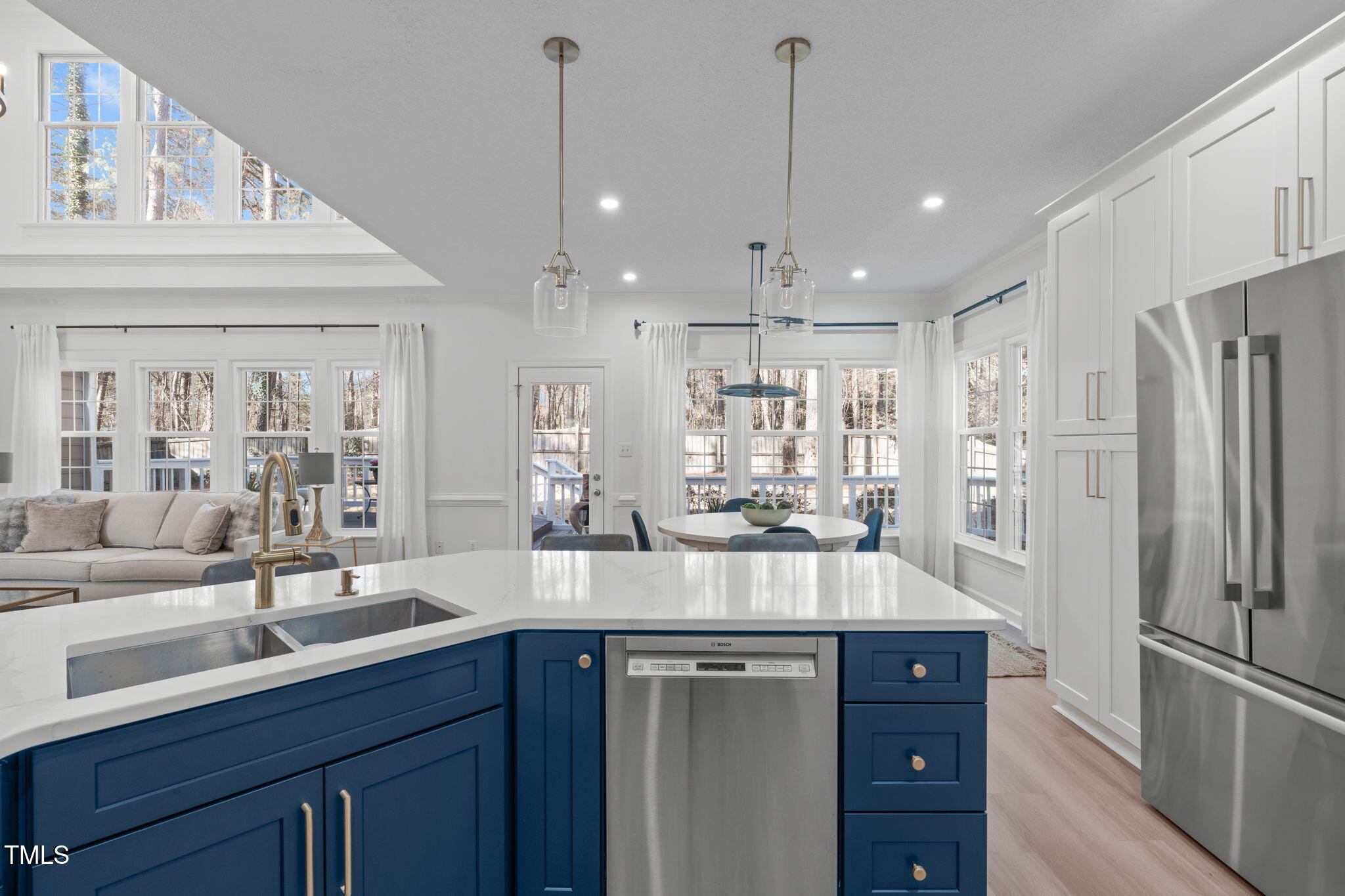 315 Barthel Drive Cary, NC 27513 - Photo 14 of 45 a kitchen with stainless steel appliances a sink a refrigerator a center island and cabinets