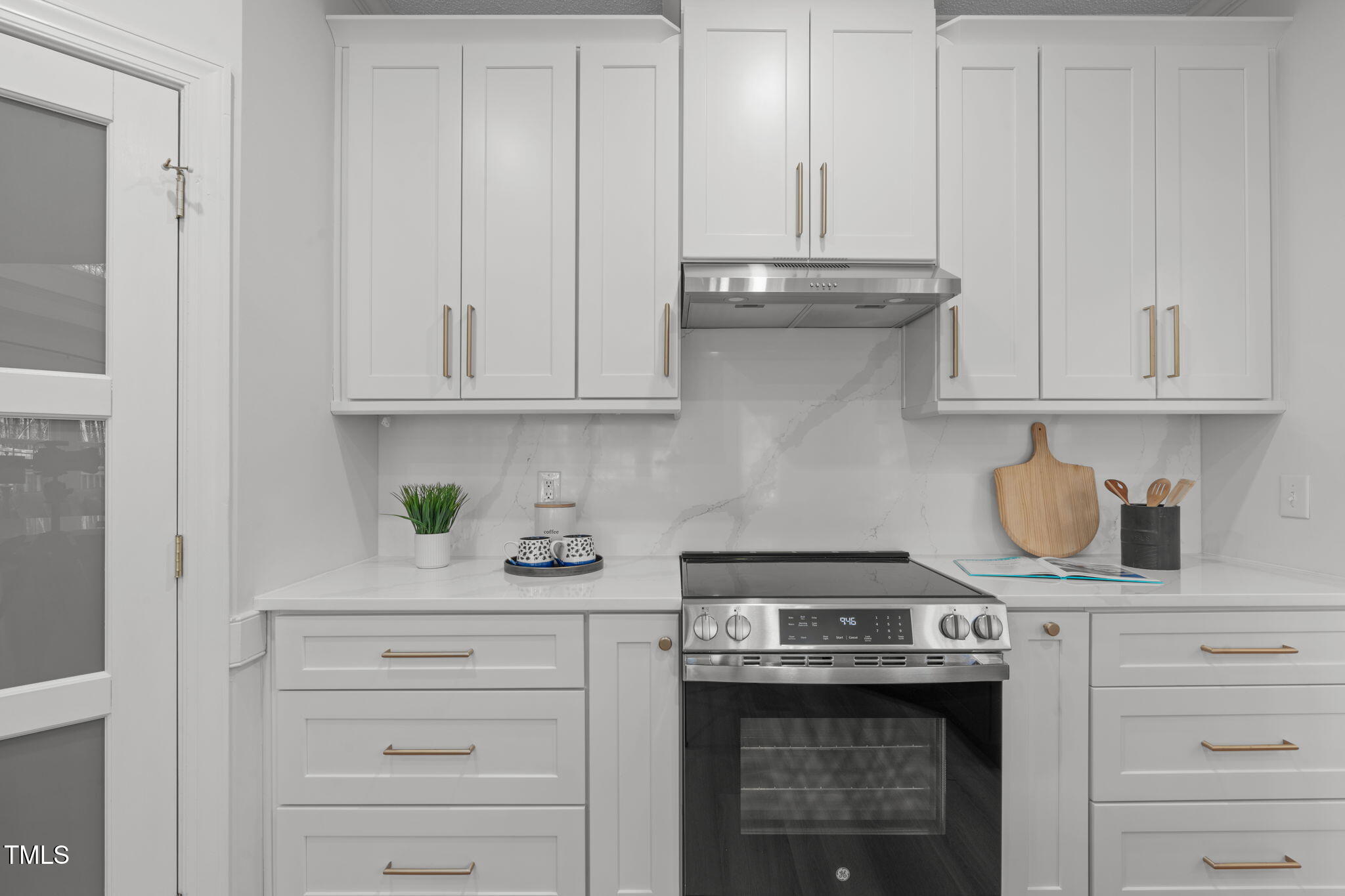 315 Barthel Drive Cary, NC 27513 - Photo 17 of 45 a kitchen with granite countertop white cabinets and a stove