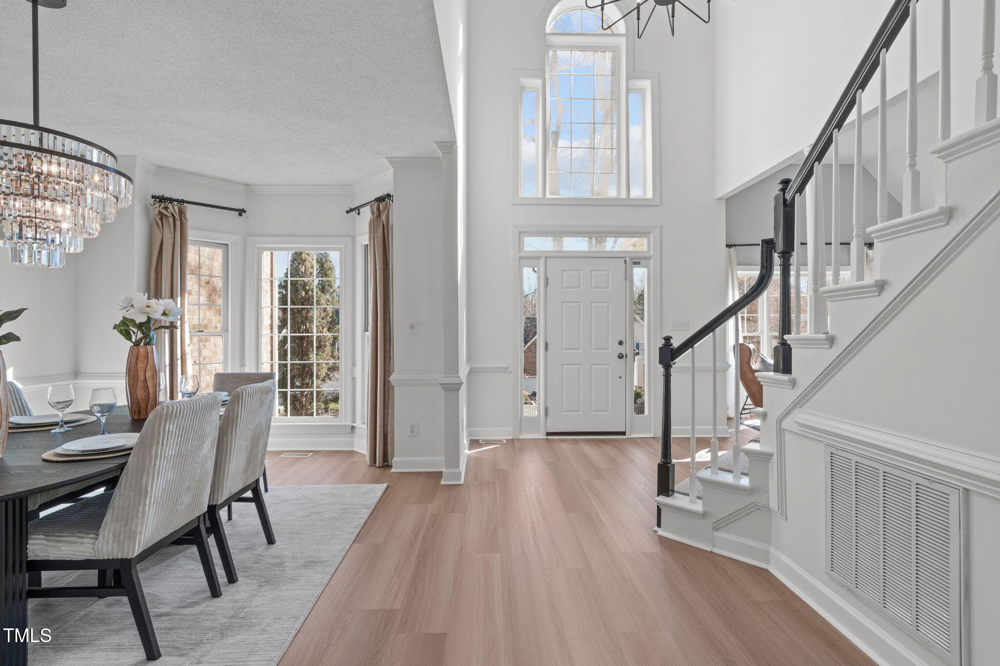 315 Barthel Drive Cary, NC 27513 - Photo 24 of 45 a view of a livingroom with furniture stairs wooden floor and windows
