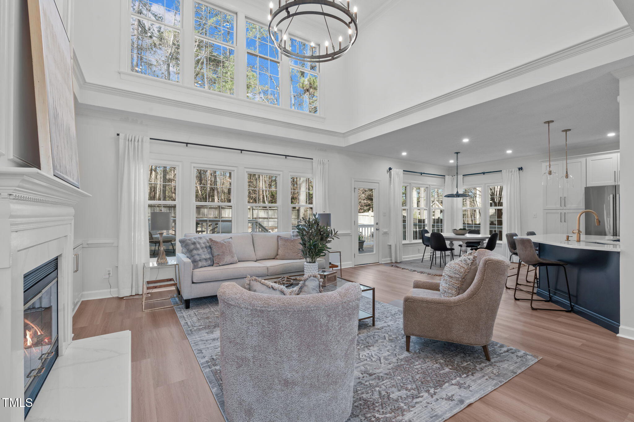315 Barthel Drive Cary, NC 27513 - Photo 9 of 45 a living room with furniture a fireplace and a chandelier