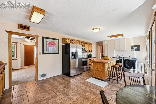 a kitchen with a refrigerator and a sink