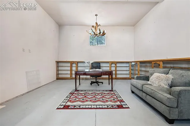 a view of a room with wooden floors and windows