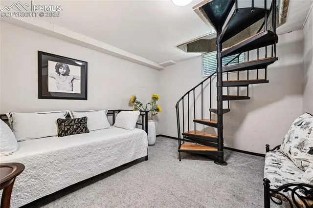 a living room with furniture and large windows