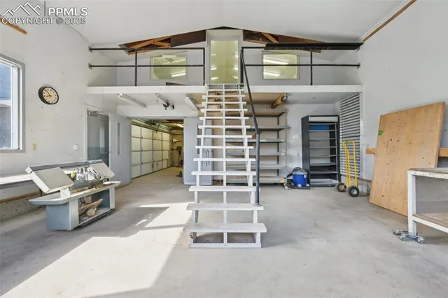 a front view of a house with a yard and mountain view in back