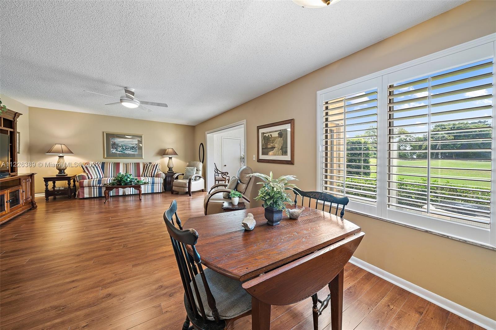 5335 Southeast Miles Grant Road, Unit 107 Stuart, FL 34997 - Photo 13 of 44 a view of a dining room with furniture window and wooden floor
