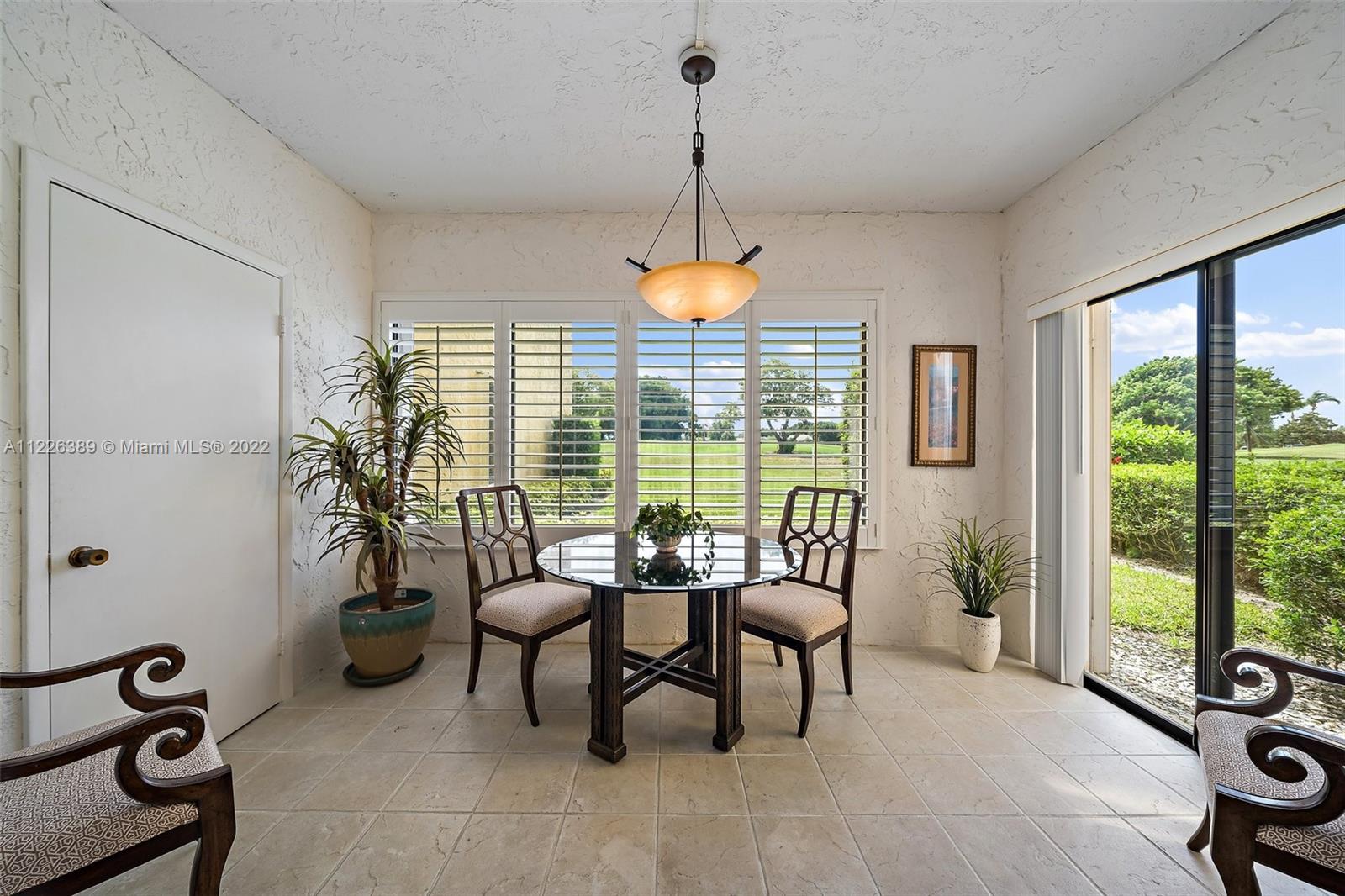 5335 Southeast Miles Grant Road, Unit 107 Stuart, FL 34997 - Photo 19 of 44 a dining room with furniture and window