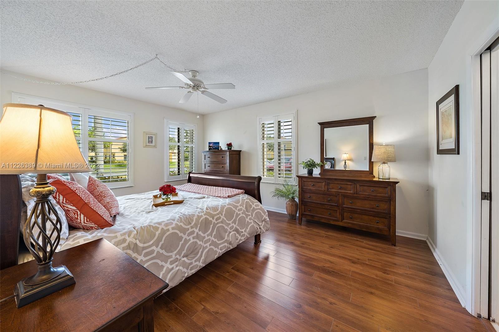 5335 Southeast Miles Grant Road, Unit 107 Stuart, FL 34997 - Photo 20 of 44 a living room with furniture and a flat screen tv