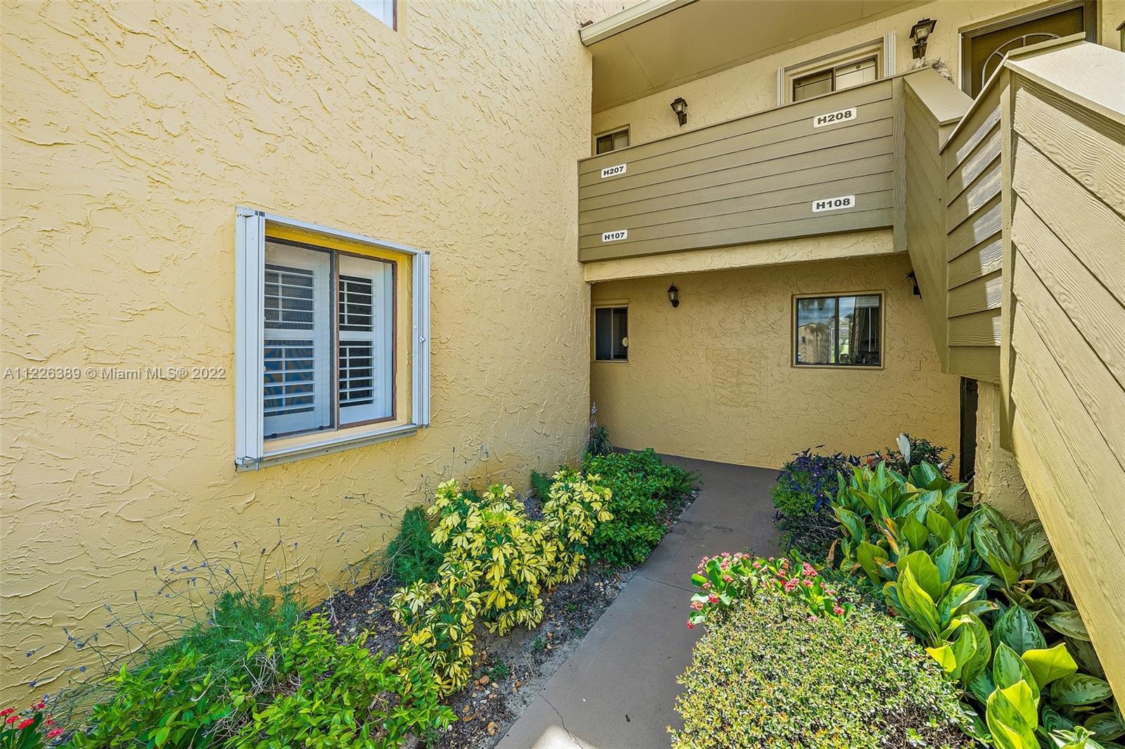 5335 Southeast Miles Grant Road, Unit 107 Stuart, FL 34997 - Photo 2 of 44 a view of a pathway of a house