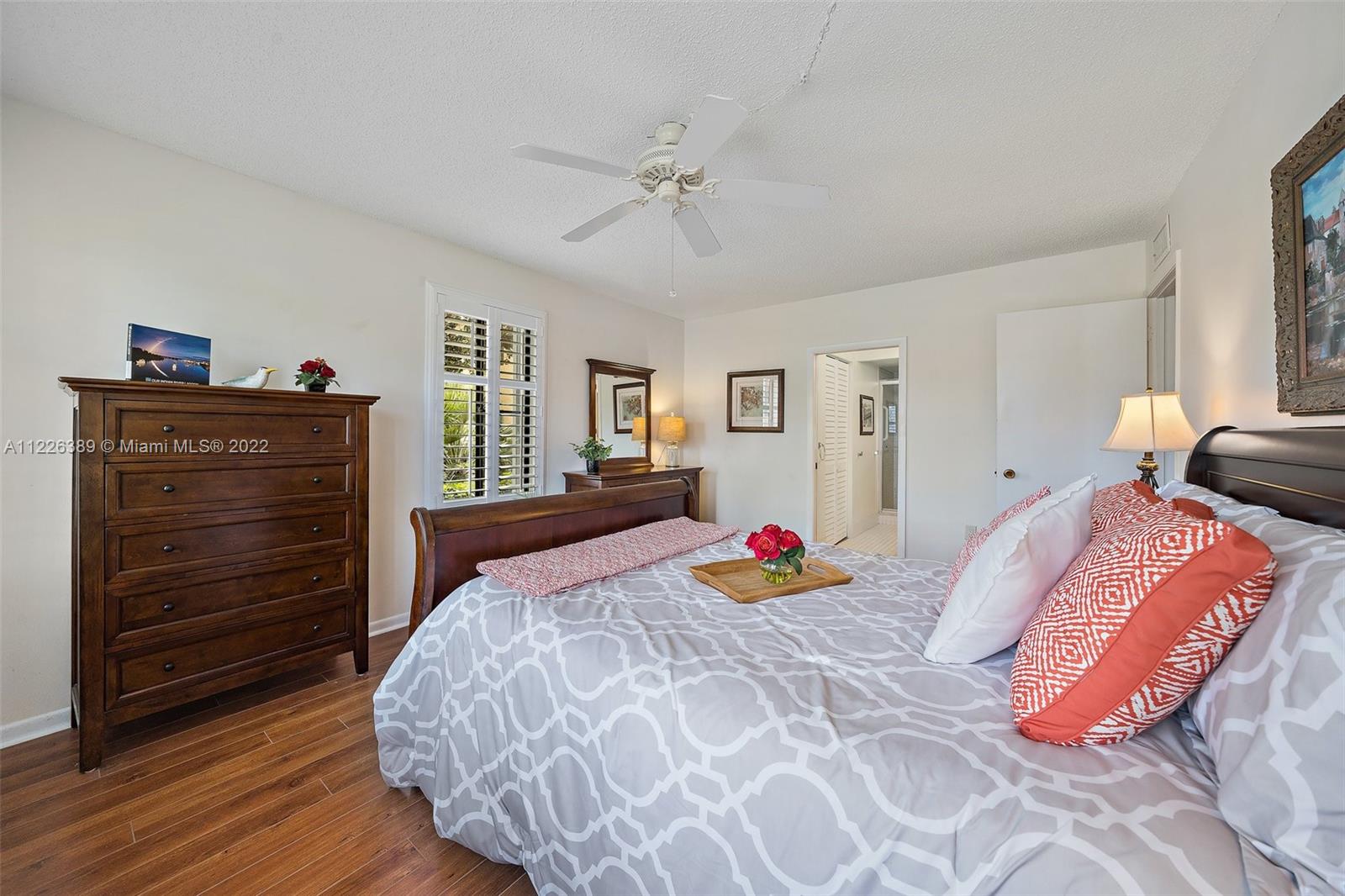 5335 Southeast Miles Grant Road, Unit 107 Stuart, FL 34997 - Photo 22 of 44 a bedroom with a bed and a closet