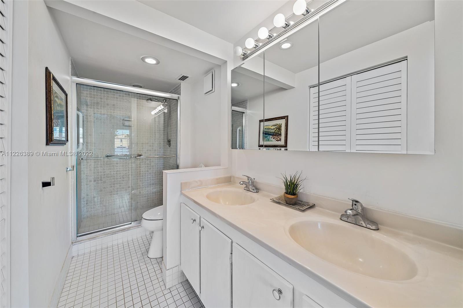 5335 Southeast Miles Grant Road, Unit 107 Stuart, FL 34997 - Photo 23 of 44 a bathroom with a sink a toilet and shower