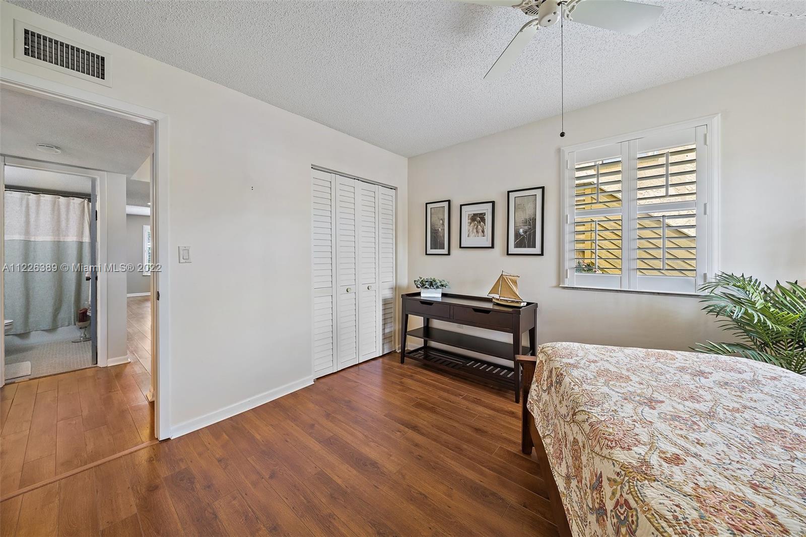 5335 Southeast Miles Grant Road, Unit 107 Stuart, FL 34997 - Photo 26 of 44 a bedroom with furniture and a window