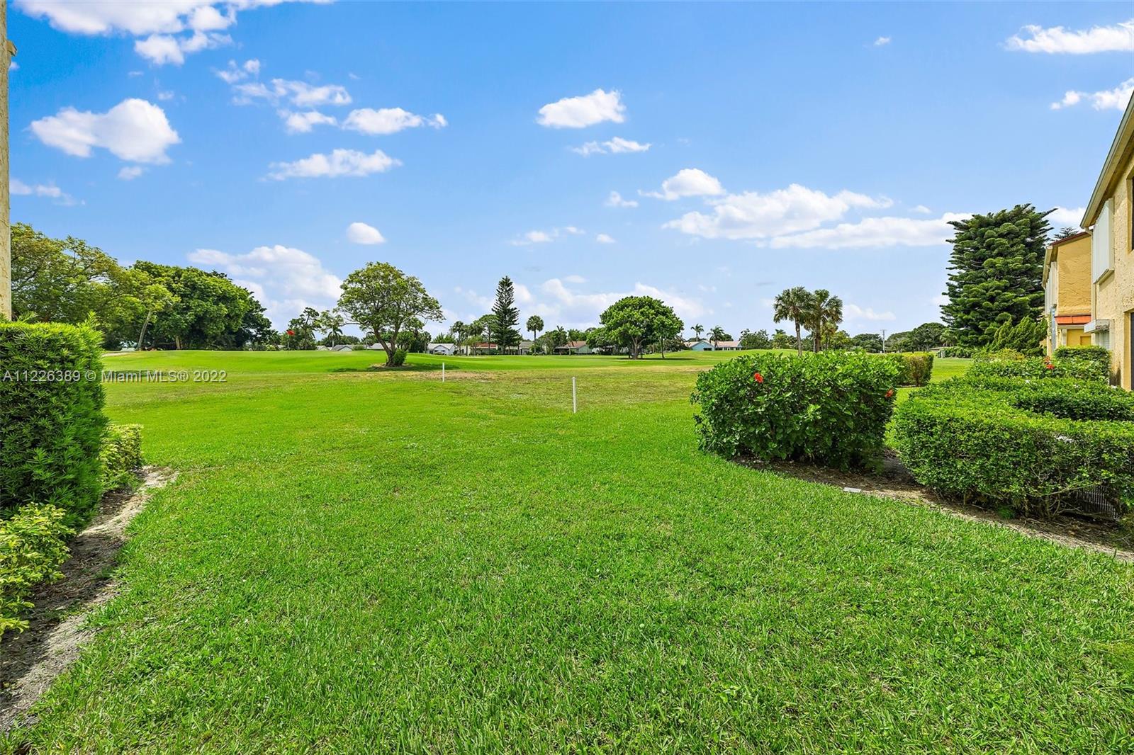 5335 Southeast Miles Grant Road, Unit 107 Stuart, FL 34997 - Photo 28 of 44 a view of a big yard with plants and large trees