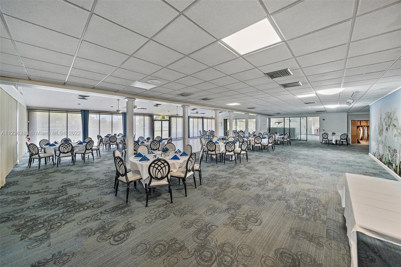 5335 Southeast Miles Grant Road, Unit 107 Stuart, FL 34997 - Photo 32 of 44 a view of a chairs and table in a room