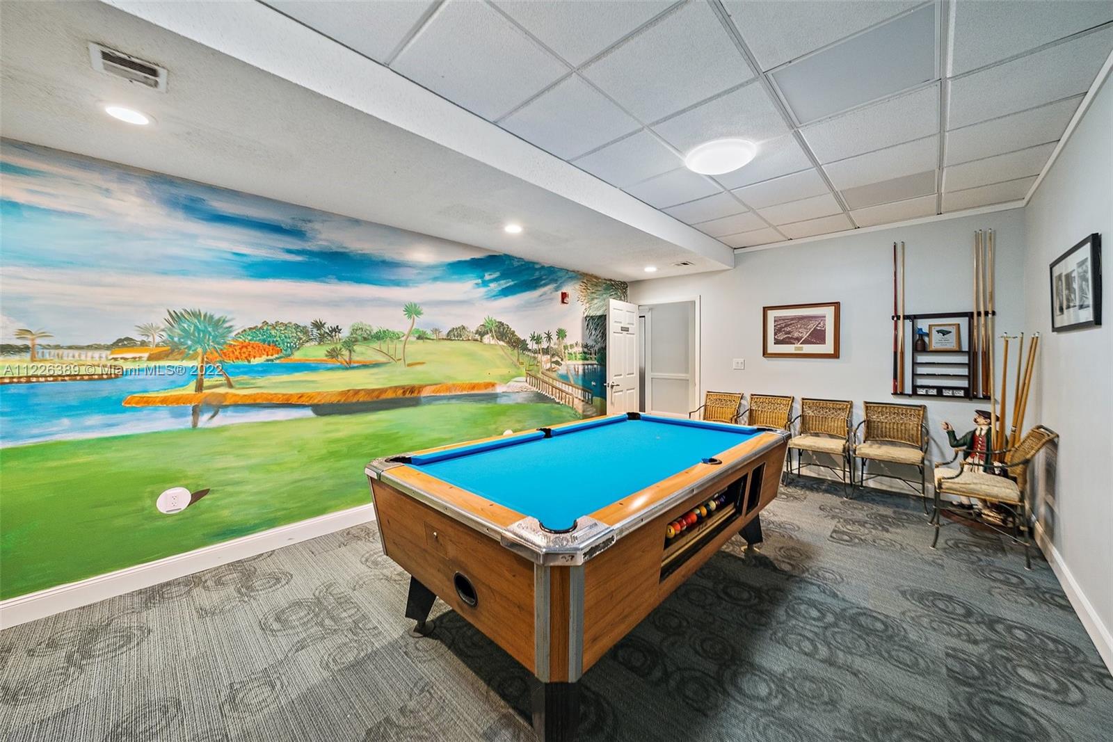 5335 Southeast Miles Grant Road, Unit 107 Stuart, FL 34997 - Photo 33 of 44 a room with pool table and rug floor