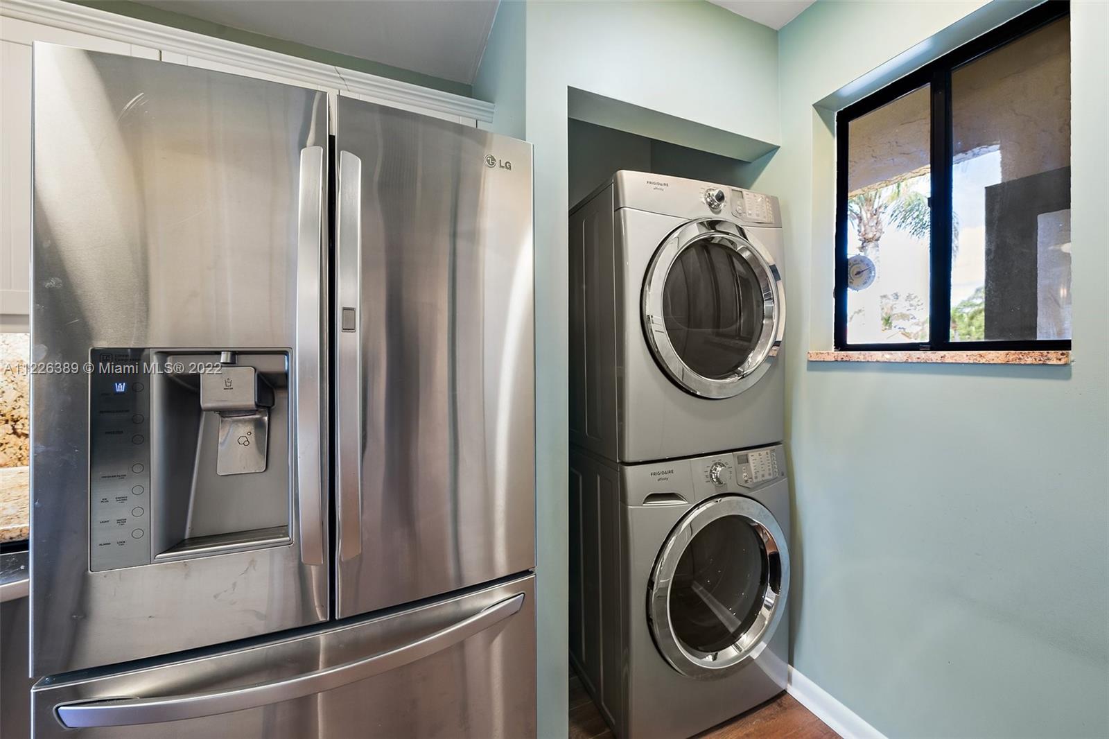 5335 Southeast Miles Grant Road, Unit 107 Stuart, FL 34997 - Photo 7 of 44 a utility room with dryer and washer