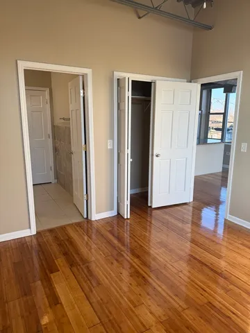 a view of a livingroom with wooden floor and staircase