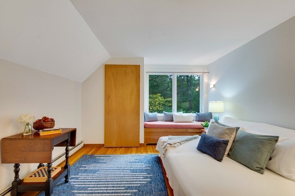 14 Baker Bridge Road Lincoln, MA 01773 - Photo 23 of 40 a bed sitting in a bedroom next to a window