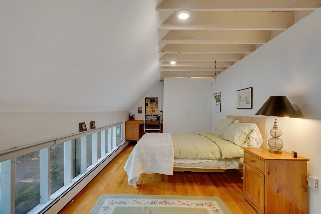 14 Baker Bridge Road Lincoln, MA 01773 - Photo 34 of 40 a bedroom with furniture and wooden floor