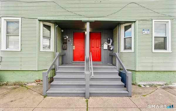 a view of a house with entrance and stairs