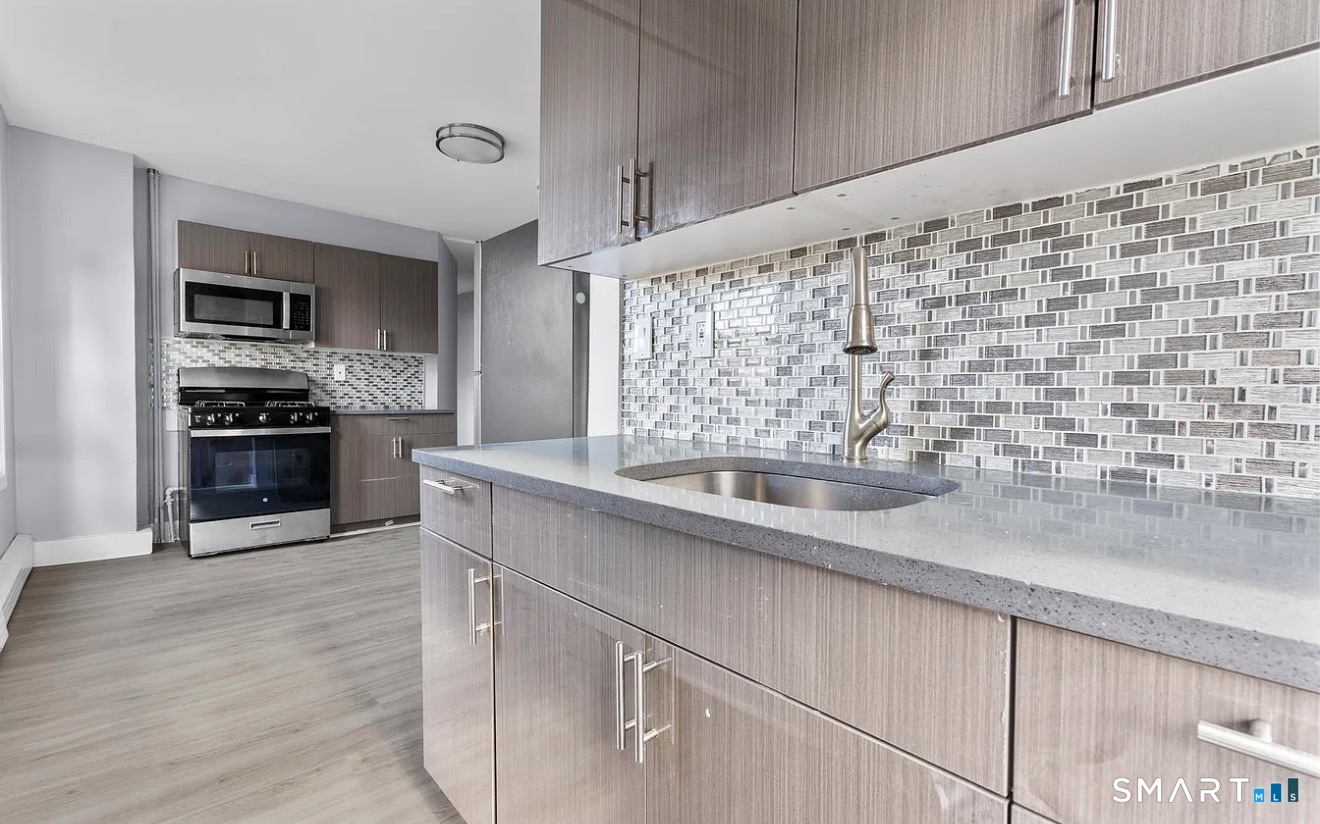 746 Maple Street Bridgeport, CT 06608 - Photo 2 of 12 a kitchen with stainless steel appliances a sink and a stove