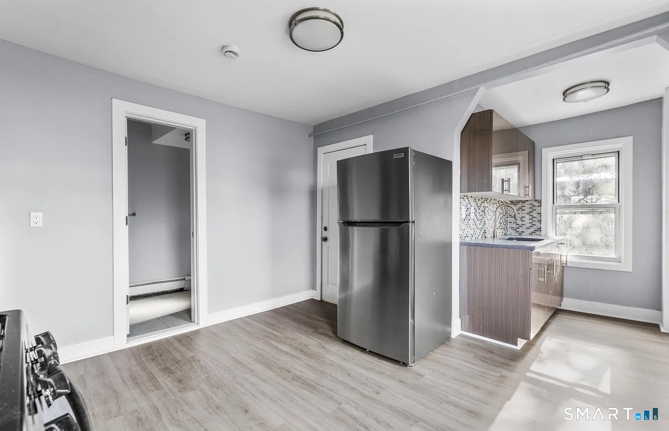 746 Maple Street Bridgeport, CT 06608 - Photo 3 of 12 a view of kitchen with furniture and refrigerator