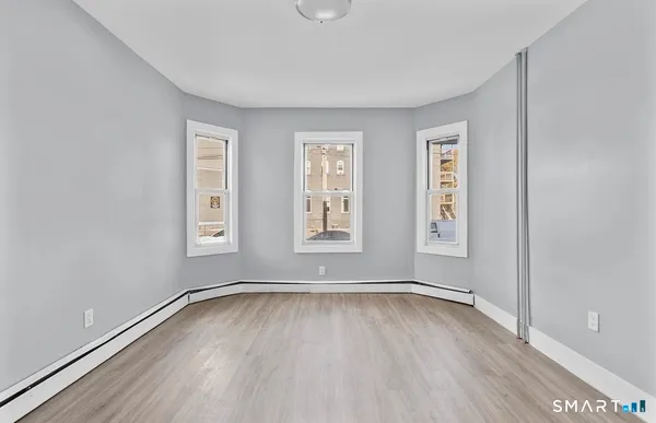 a view of room with window and hardwood floor