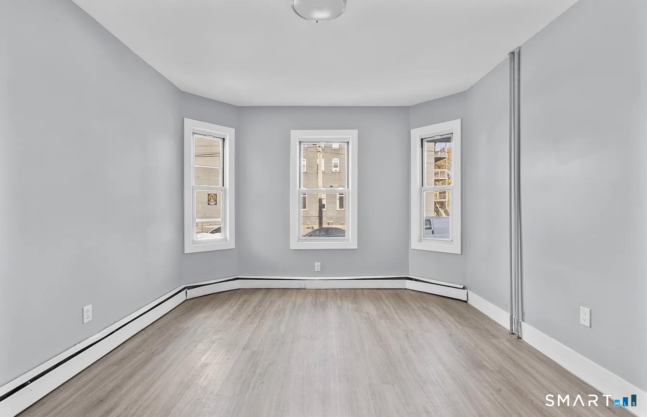 746 Maple Street Bridgeport, CT 06608 - Photo 5 of 12 a view of room with window and hardwood floor