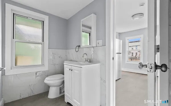 a spacious bathroom with a toilet sink and a mirror