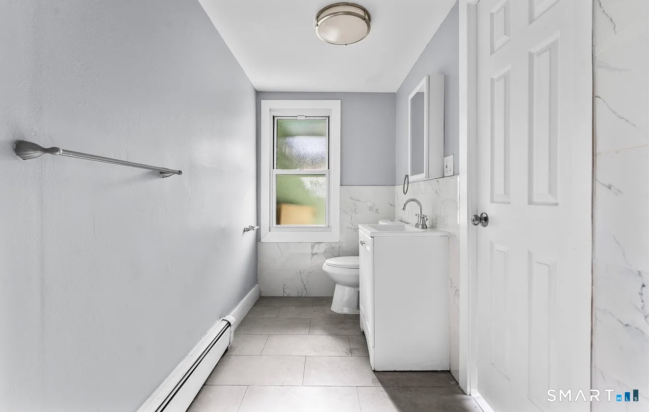 746 Maple Street Bridgeport, CT 06608 - Photo 9 of 12 a bathroom with a sink a toilet and shower
