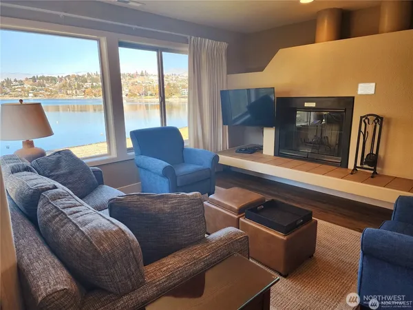 a living room with furniture and a floor to ceiling window