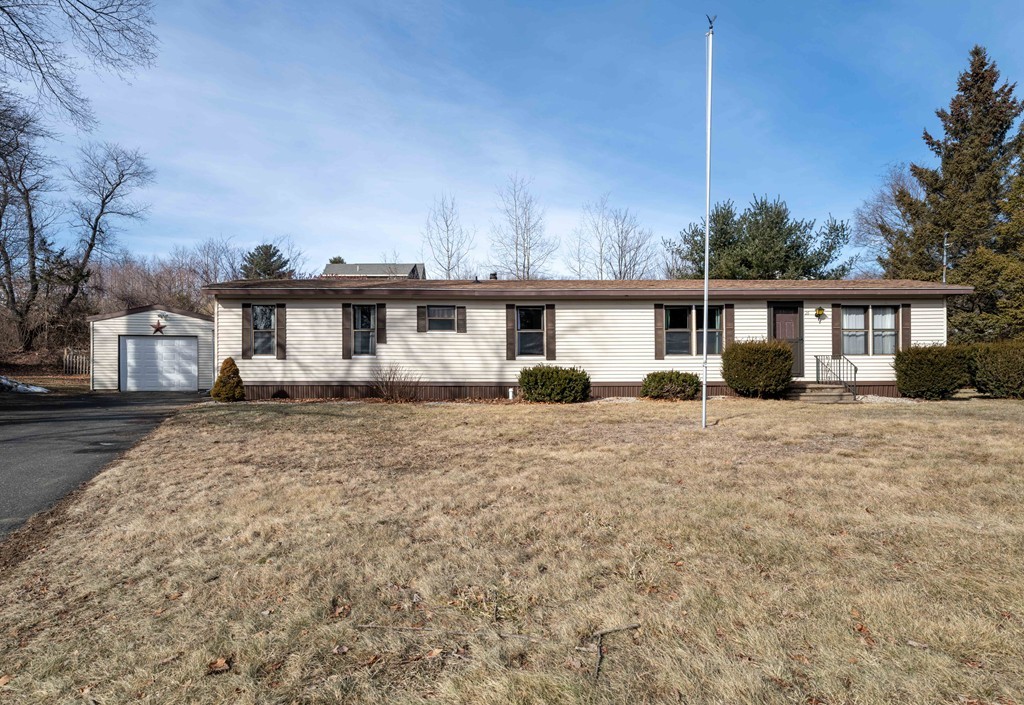 26 Gould Road Ware, MA 01082 - Photo 1 of 23 a front view of a house with a garden