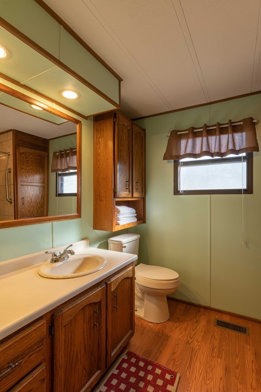 26 Gould Road Ware, MA 01082 - Photo 14 of 23 a bathroom with a sink a toilet a mirror and shower