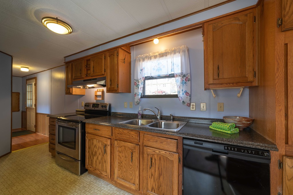 26 Gould Road Ware, MA 01082 - Photo 6 of 23 a kitchen with granite countertop a sink a stove cabinets and a window
