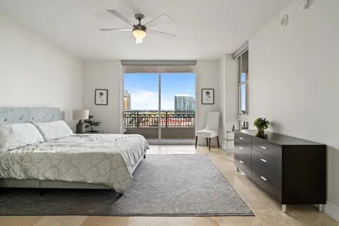 a bedroom with a large bed and a chandelier