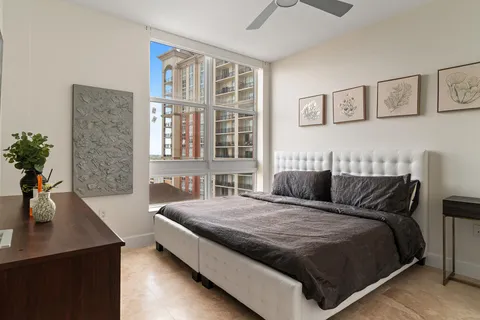 a bed sitting in a bedroom next to a window