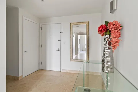 a view of an entryway with wooden floor