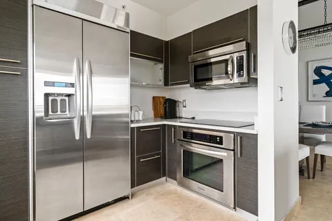 a kitchen with stainless steel appliances granite countertop a stove and a refrigerator