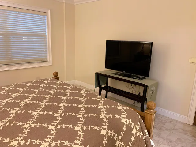 a bedroom with a bed and a flat screen tv