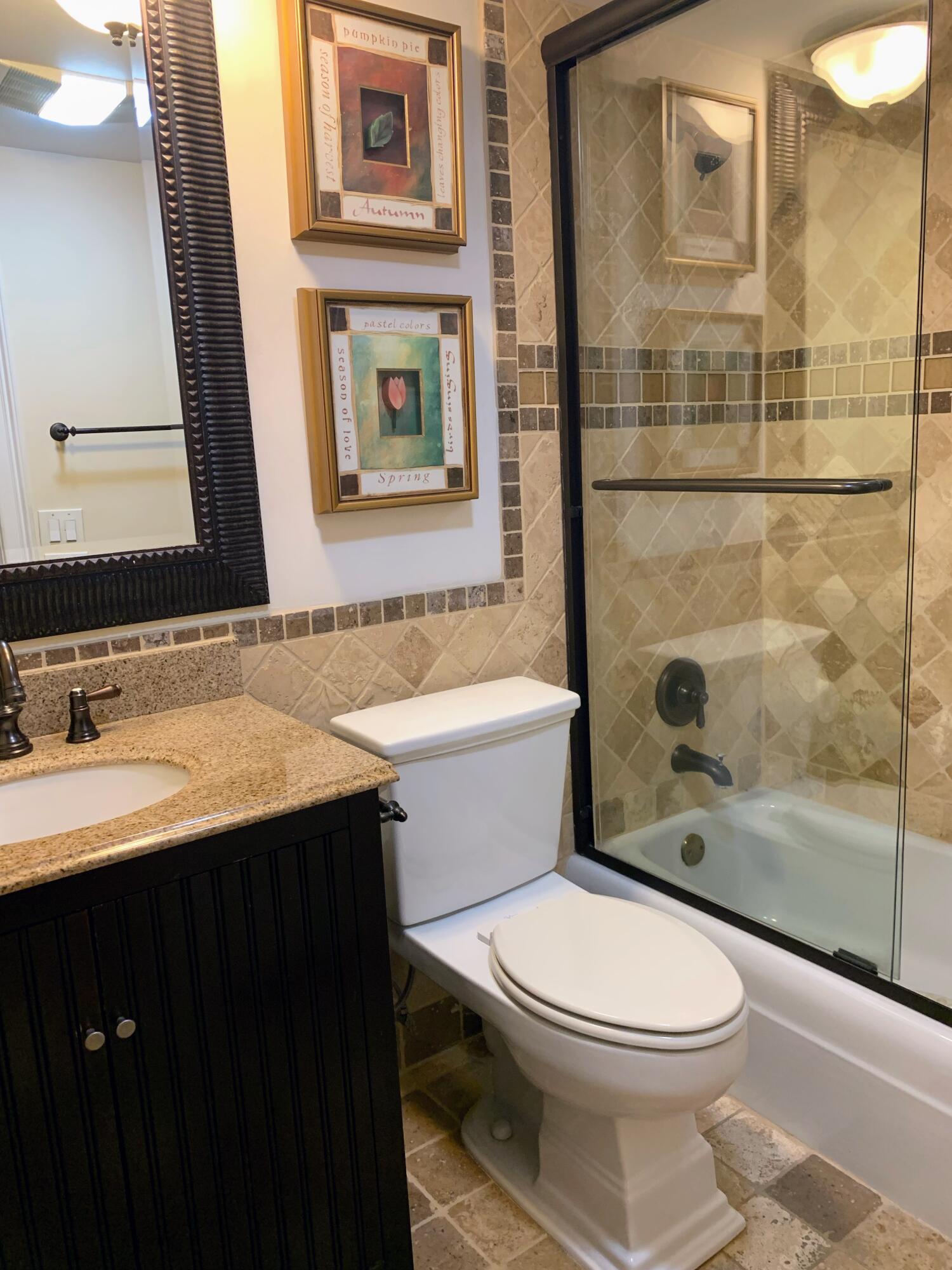 3101 South Ocean Boulevard, Unit 712 Highland Beach, FL 33487 - Photo 15 of 25 a bathroom with a sink a toilet and shower