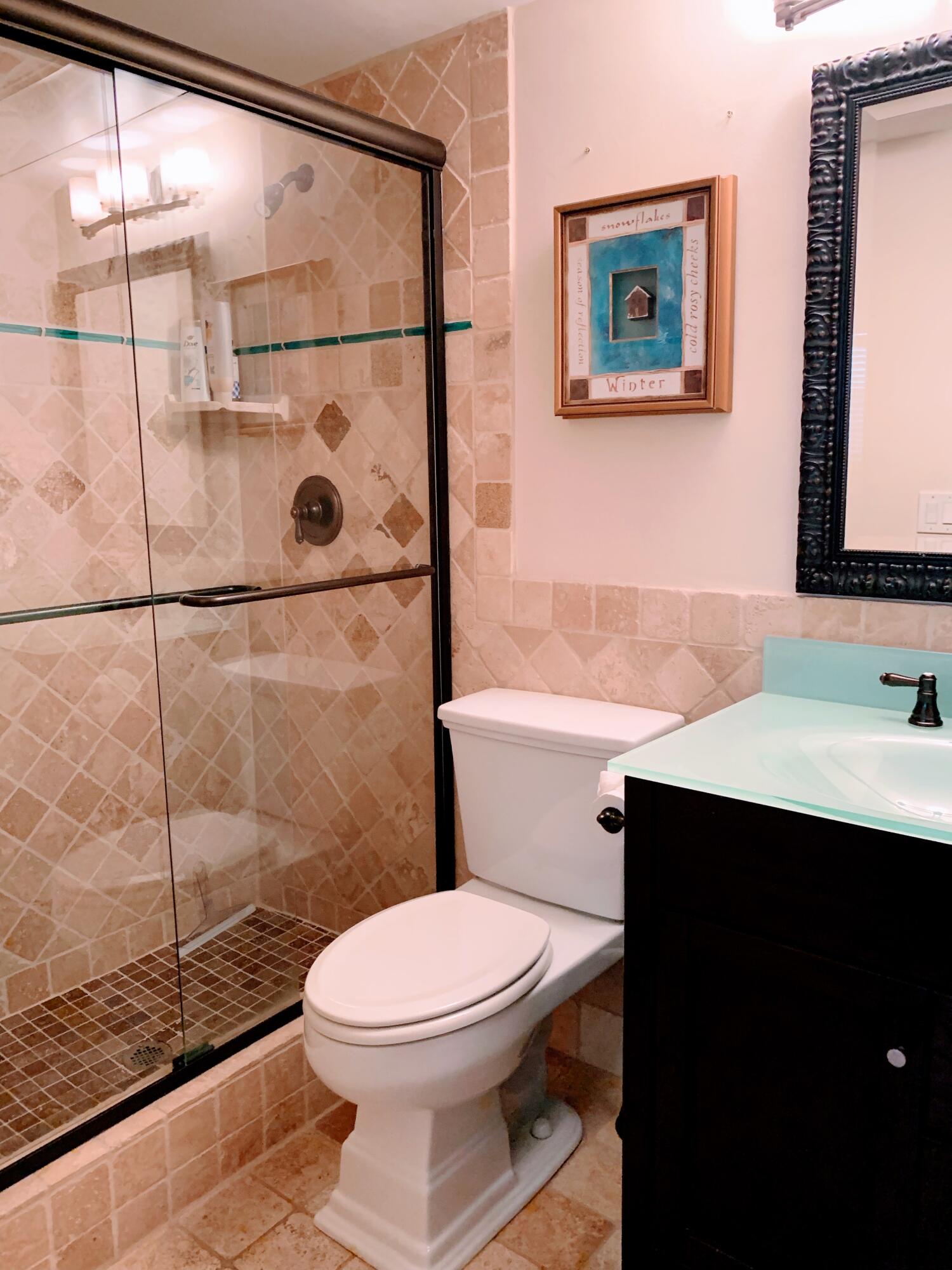 3101 South Ocean Boulevard, Unit 712 Highland Beach, FL 33487 - Photo 16 of 25 a bathroom with a sink a toilet and shower