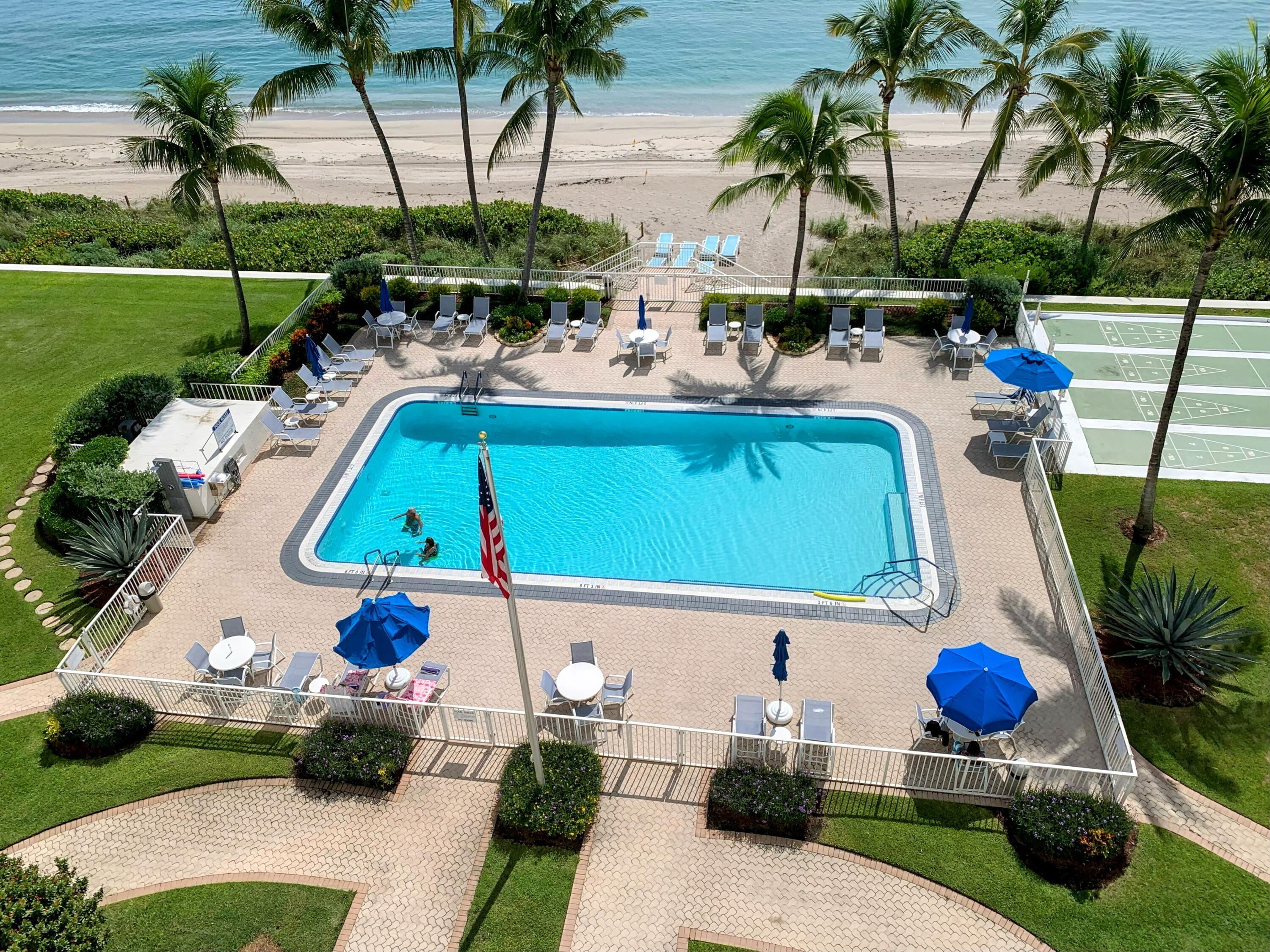 3101 South Ocean Boulevard, Unit 712 Highland Beach, FL 33487 - Photo 17 of 25 a view of a swimming pool with a table and chairs
