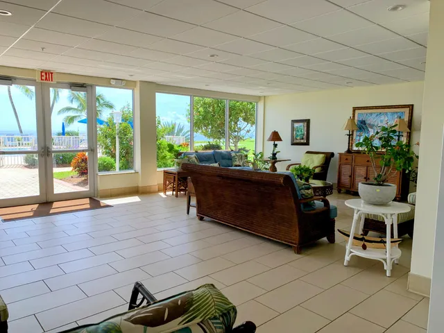 a living room filled with furniture and a floor to ceiling window