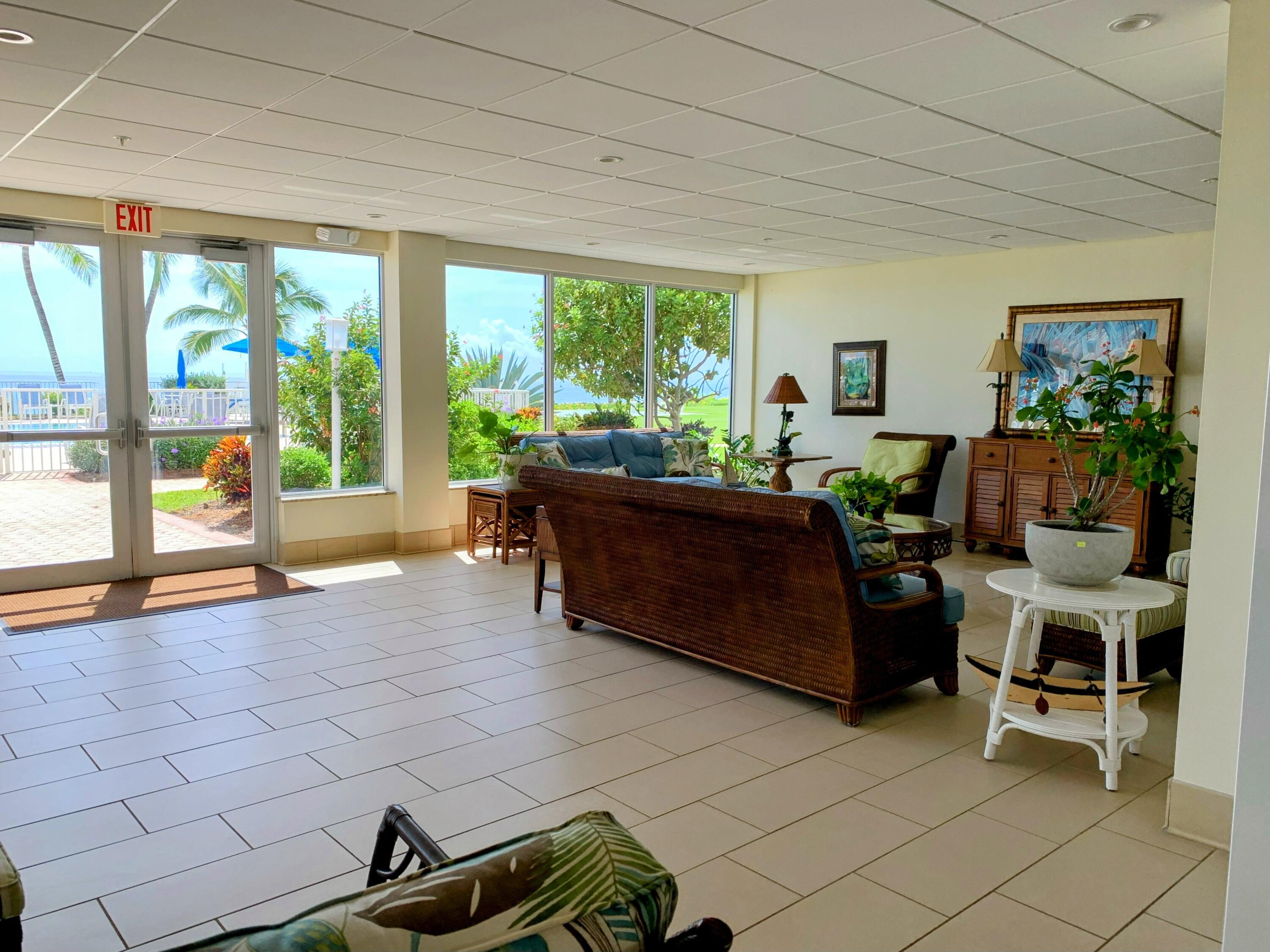 3101 South Ocean Boulevard, Unit 712 Highland Beach, FL 33487 - Photo 20 of 25 a living room filled with furniture and a floor to ceiling window